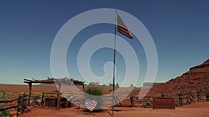 Beautiful scenic view of American flag waving in Wild West museum with old wooden relics in the middle of hot desert.