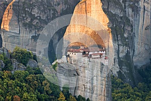 Beautiful scenic view, Orthodox Monastery of Rousanou St. Barbara, immense monolithic pillar, green and yellow foliage