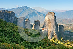 Beautiful scenic view, Orthodox Monastery of Rousanou St. Barbara, immense monolithic pillar, green and yellow foliage