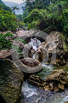 The beautiful scenic waterfall in front of famous double decker root bridge in meghalaya