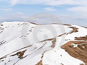 Beautiful scenic winter landscape from Carpathian Mountains in Romania. Lonely hiker