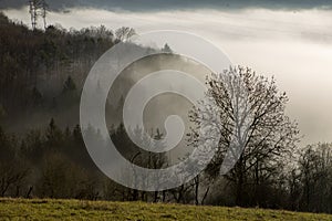 Beautiful scenic winter landscape with a fog filled valley