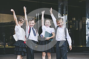 Beautiful school children active and happy on the background of