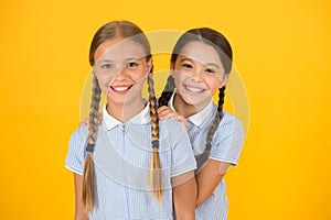 Beautiful schoolgirls. Back to school concept. Cute schoolgirls. Girls with braided hair style. Hairdresser salon photo