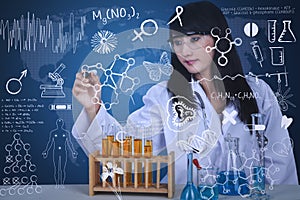 Beautiful scientist drawing formula at lab