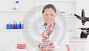 Beautiful scientist showing the dna