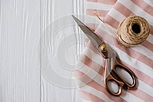 Beautiful scissors, striped fabric and twine spool