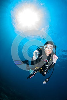 Beautiful Scuba diver smile cheerfully .