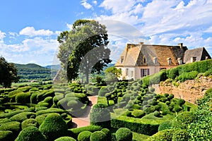 Sculpted gardens with house, Dordogne, France photo