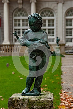 Beautiful sculpture of little kid with angry fish