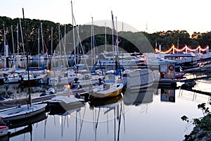 Beautiful sea, river landscape with boats and yachts on the Wiesbaden pier in Germany, evening lights and reflections in the water