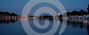 Beautiful sea, river landscape with boats and yachts on the Wiesbaden pier in Germany, evening lights and reflections in the water