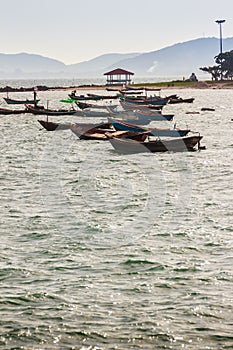 Beautiful sea, sand and fishing boats with mountain and blue sky photo