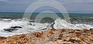 Beautiful sea with a stone shore. Sea background. Mediterranean Sea in Torrevieja in Spain.