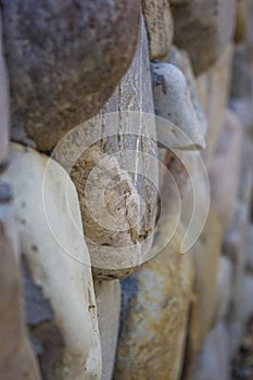 Beautiful sea stones in the masonry of the wall of boulders