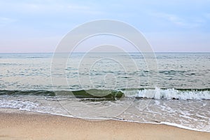 Beautiful sea summer abstract background. Golden sand beach with blue ocean and cloudscape and sunset in the back