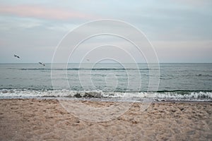 Beautiful sea summer abstract background. Golden sand beach with blue ocean and cloudscape and sunset in the back