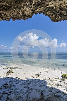 Beautiful sea view, blue sky and white clouds from the inside of the cliff on the island of Zanzibar, Tanzania, Africa. Travel and
