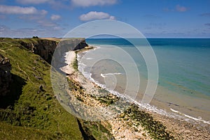 Beautiful sea view with a cliff beachline and blue cloudy sky