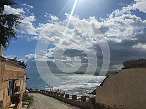 Beautiful sea view from the cliff with white black clouds during the day