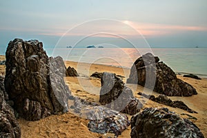 Beautiful sea view landscape with sunset light and big magmatic rock on the coastline photo