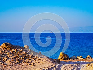 Beautiful sea view from sandy beach with mountains in the background