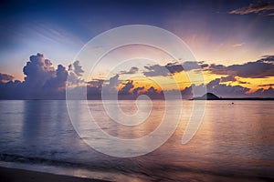 beautiful sea view scenery over stunning sunrise background.sunlight beam and soft wave hitting sandy beach