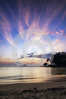 Beautiful sea view scenery over stunning sunrise background. sunlight beam and soft wave hitting sandy beach