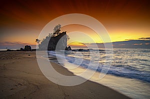 beautiful sea view scenery over stunning sunrise background.sunlight beam and soft wave hitting sandy beach