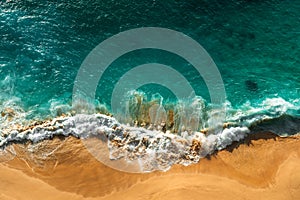 Beautiful sea wave at sunset from a bird`s eye view. Beautiful lonely beach at sunset