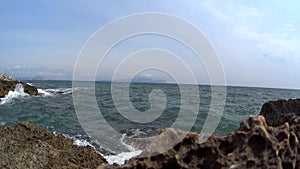 Beautiful sea waves rocky point Spain. Ocean beach, cliff and beautiful scenery along coast