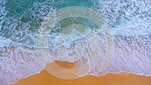 Beautiful sea waves and white sand beach in the tropical island. Soft waves of blue ocean on sandy beach background from top view