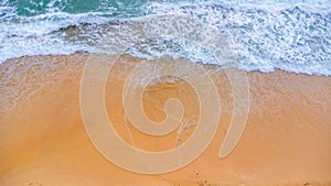 Beautiful sea waves and white sand beach in the tropical island. Soft waves of blue ocean on sandy beach background from top view