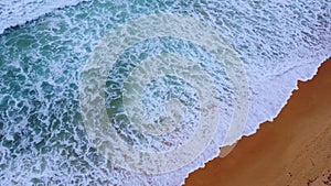 Beautiful sea waves and white sand beach in the tropical island. Soft waves of blue ocean on sandy beach background from top view