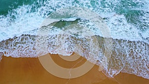 Beautiful sea waves and white sand beach in the tropical island. Soft waves of blue ocean on sandy beach background from top view
