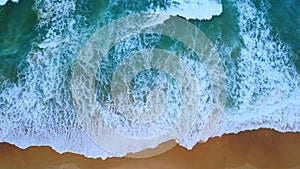 Beautiful sea waves and white sand beach in the tropical island. Soft waves of blue ocean on sandy beach background from top view