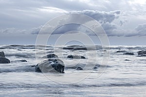 Beautiful seascape background, rocks in the Irish Sea at Seascale beach, Cumbria, England, United Kingdom