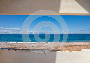 Beautiful seascape with calm sea, sandy beach, blue sky of suburb in South Athens located in the Athens Riviera, Greece.