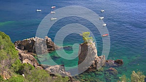 Beautiful seascape at La Grotta Bay, Corfu, sunny summer day - small boats on calm sea in distance