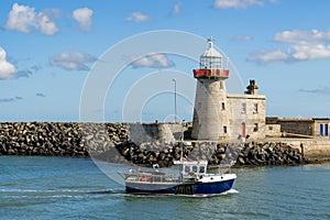 Beautiful seascape - lighthouse with passing boat