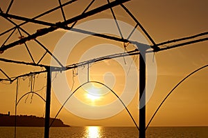 Beautiful seascape at sunset in orange tone in an abandoned gazebo. Resort on the Black Sea