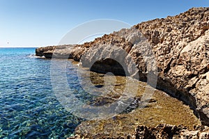 Beautiful seascape. Travel concept. Seascape on the background of the wild rocky coast. Wild beach, azure water and rocks