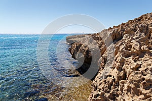 Beautiful seascape. Travel concept. Seascape on the background of the wild rocky coast. Wild beach, azure water and rocks