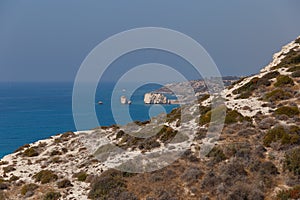 Beautiful seascape. Travel concept. Seascape on the background of the wild rocky coast. Wild beach, azure water and rocks