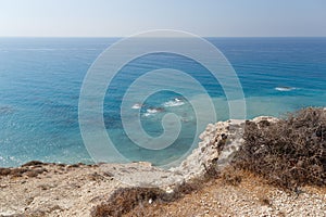 Beautiful seascape. Travel concept. Seascape on the background of the wild rocky coast. Wild beach, azure water and rocks