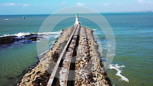 A beautiful seascape, a view of a lighthouse on the ocean, shot from a drone in 4K