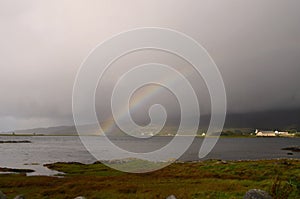 Beautiful seascape view with stunning rainbow in Scotland