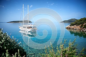 Beautiful seascape, a white yacht stands on the shore of the turquoise Mediterranean Sea