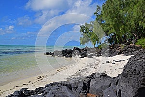 Beautiful secluded Beach surrounded with Black Rocks at Ile aux Cerfs Mauritius