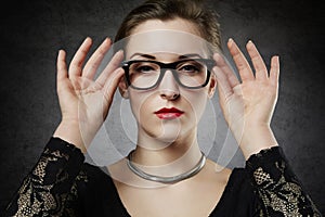 Beautiful seducing femme fatale in nerdy glasses photo